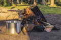 Cooking in a metal saucepan on the fire in the forest Camp. Leisure. Lifestyle