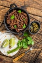 Cooking of mexican pork carnitas taco. Wooden background. Top view Royalty Free Stock Photo