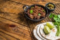 Cooking of mexican pork carnitas taco. Wooden background. Top view. Copy space Royalty Free Stock Photo