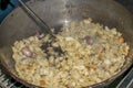 Cooking migas or Crumbs a typical spanish food. Crumbs prepared in a frying pan