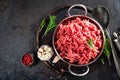 Cooking mince. Raw ground veal meat with ingredients for cooking on black kitchen table. Fresh minced meat