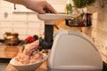 Cooking minced meat in an electric meat grinder on the kitchen table