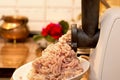 Cooking minced meat in an electric meat grinder on the kitchen table Royalty Free Stock Photo