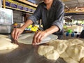Making roti canai or paratha bread at the local stall in Malaysia.