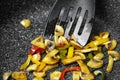 Cooking mushrooms with vegetables  in hot seed oil in a frying grill pan with non-stick coating. Roasting colorful bell peppers Royalty Free Stock Photo