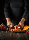 Cooking a national delicious pumpkin dish with the hands of a professional chef in a restaurant kitchen. Work environment on the Royalty Free Stock Photo