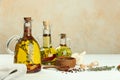 Cooking oil with different spices and herbs in jugs on white wooden table. Space for text Royalty Free Stock Photo