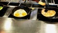 Cooking omelettes and fried eggs. Breakfast buffet in restaurant Royalty Free Stock Photo