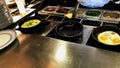 Cooking omelettes and fried eggs. Breakfast buffet in restaurant Royalty Free Stock Photo