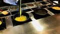 Cooking omelettes and fried eggs. Breakfast buffet in restaurant Royalty Free Stock Photo