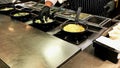 Cooking omelettes and fried eggs. Breakfast buffet in restaurant Royalty Free Stock Photo