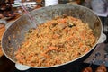 Cooking oroginal Uzbek pilaf in big wok. Preparation of pilaf. Street food Royalty Free Stock Photo