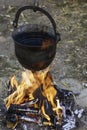 Cooking outdoor in a old tin kettle from middle age