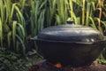 Cooking outdoors wok cooking pot on fire preparing food background