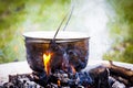 Cooking over open fire outdoors in the forest Royalty Free Stock Photo
