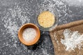 Cooking paella with salt and rice on dark desk background top view