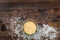 Cooking paella with salt and rice on wooden desk background top view mockup