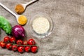 cooking paella with vegetables and rice on brown fabric background top view mockup