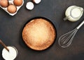 Cooking pancakes on a concrete background, top view. Pancake ingredients: milk, eggs, flour