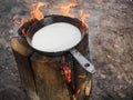 Cooking pancakes on a finnish candle. Maslenitsa holiday