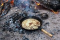 Cooking pancakes on the fire in the forest.