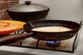 Cooking pancakes. Thin pancake is fried in a pan. Traditional rustic food