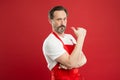 Cooking is passion. Cook with beard and mustache wear apron red background. Man mature cook posing cooking apron. Fine Royalty Free Stock Photo