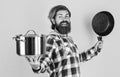 Cooking with passion. professional cook. bearded man hold kitchen pan. brutal hipster cooking with saucepan. housekeep Royalty Free Stock Photo