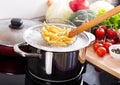 Cooking pasta in a pot with boiling water on a cooker Royalty Free Stock Photo