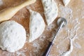 Cooking patty. The dough, rolling pin and raw pies on the table