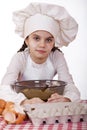 Cooking and people concept - smiling little girl in cook hat Royalty Free Stock Photo