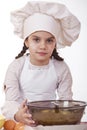 Cooking and people concept - smiling little girl in cook hat Royalty Free Stock Photo