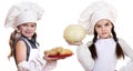 Cooking and people concept - Two Little girls in a white apron