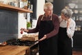 Cooking, pepper and senior couple in kitchen at home with ingredients for healthy diet meal. Love, food and elderly man Royalty Free Stock Photo