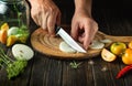 Cooking pickled vegetables in a jar. The cook cuts the onion with a knife on the cutting board of the kitchen. Close-up of chef Royalty Free Stock Photo
