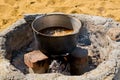 Cooking pilaf in a large cauldron over an open fire. Close-up Royalty Free Stock Photo