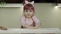 Cooking pizza. Little child in apron preparing dough for cooking at home kitchen Royalty Free Stock Photo