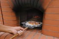 Cooking pizza. Cook prepares pizza in professional open fire oven. Italian cuisine Royalty Free Stock Photo