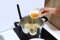 Cooking Porridge for baby food in pot on electric stove