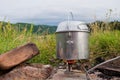 Cooking on a portable gas burner in outdoor conditions hikes Royalty Free Stock Photo