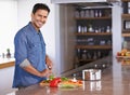 Cooking, portrait and happy man chopping vegetables on kitchen counter for healthy diet, nutrition or lunch. Cutting Royalty Free Stock Photo