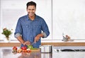 Cooking, portrait and happy man cutting vegetables on kitchen counter for healthy diet, nutrition or lunch. Chopping Royalty Free Stock Photo