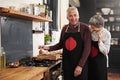 Cooking, portrait and senior couple in kitchen at home with ingredient for health diet meal. Laughing, food and elderly Royalty Free Stock Photo