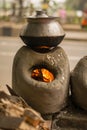 Cooking pot on a traditional south Asian stove made by soil in the road side street food shop Royalty Free Stock Photo