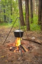 Cooking in pot on campfire, camp cooking, pot with hot food