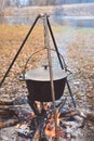 Cooking in pot on campfire, camp cooking, pot with hot food