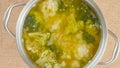 Cooking pot with cauliflower broccoli soup close-up on a table on a rustic background Royalty Free Stock Photo