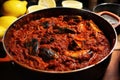 cooking pot full of steaming mussels in marinara sauce Royalty Free Stock Photo