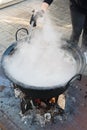 Cooking pot over campfire, stew preparing open grill steaming. Outdoor fireplace camping concept Royalty Free Stock Photo