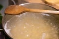 cooking pot with water and wooden spoon